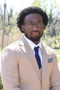 An informal portrait of young researcher, he is outside on academic row