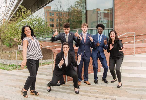 A group of five students celebrating their shcolarship awards with their mentor.