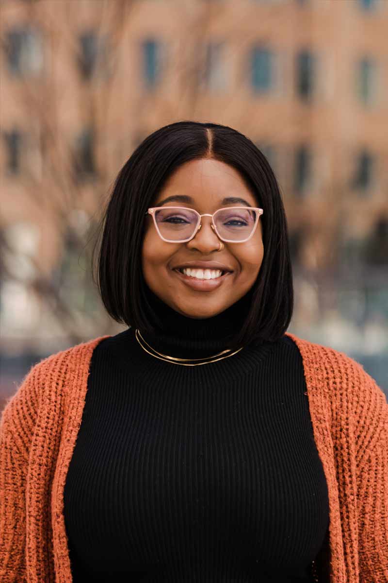 An informal portrait of young researcher, she is smiling at the camera