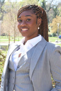 An informal portrait of young researcher, she is outside on academic row