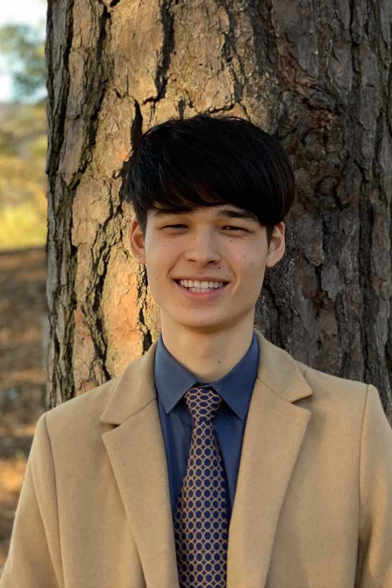 An informal portrait of young researcher, he is smiling at the camera