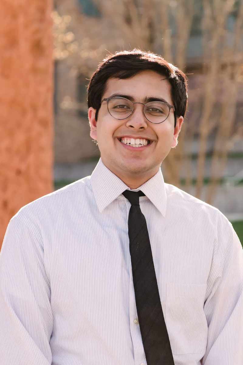 An informal portrait of young researcher, he is smiling at the camera