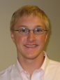 An informal portrait of young researcher, he is smiling at the camera
